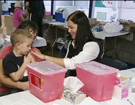 A child receives the H1N1 flu vaccine at a flu clinic in Ottawa, Thursday, Oct. 29, 2009.
