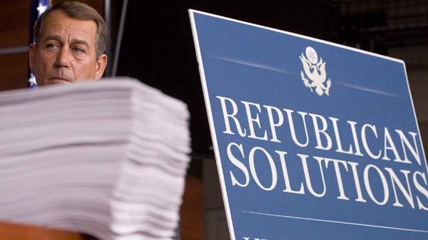 U.S. House Minority Leader John Boehner stands behind copies of the Democrat health care bill during a news conference on Capitol Hill in Washington, on Oct. 29, 2009. (AP / Harry Hamburg)