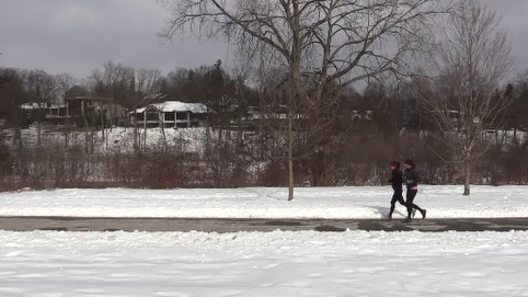 Two woman jog along the Maurice Chapman Walkway at Springbank Park in London, Ont. Saturday Feb 6, 2021 (Brent Lale/CTV News)