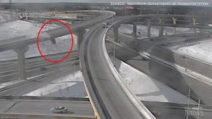 Wisconsin Department of Transportation's traffic camera caught the moment a vehicle fell off an elevated highway and landed upright.  