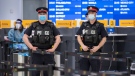 Police and workers wait for arrivals at the COVID-19 testing centre in Terminal 3 at Pearson Airport in Toronto on Wednesday, February 3, 2021. THE CANADIAN PRESS/Frank Gunn