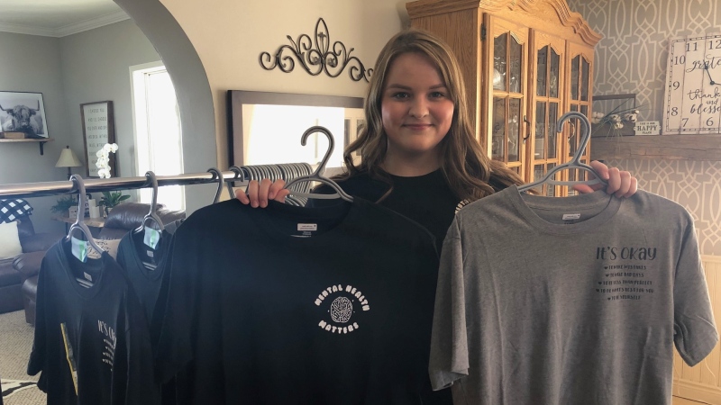 High school student Julia Redick shows off her two T-Shirt designs to promote mental health awareness on Wednesday, Feb. 10, 2021. (Jordyn Read/CTV News)