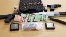 Guns, drugs and cash seized in London, Ont. on Wednesday, Feb. 10, 2021 are seen in this image released by the London Police Service.