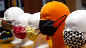 Face masks modelled on styrofoam heads in a tailor shop in Lichtenstein (Saxony), Germany, Friday, March 20, 2020. (AP Photo/Jens Meyer)