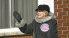 Lois Lombard waves to a parade of vehicles to celebrate her 100th birthday in Brockville. (Nate Vandermeer/CTV News Ottawa
