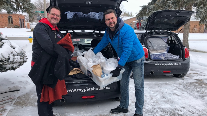Shawn Amerlinck and Michael-John Knoblauch deliver baskets in Windsor, Ont. on Saturday, Feb. 13, 2021. (Alana Hadadean/CTV Windsor)
