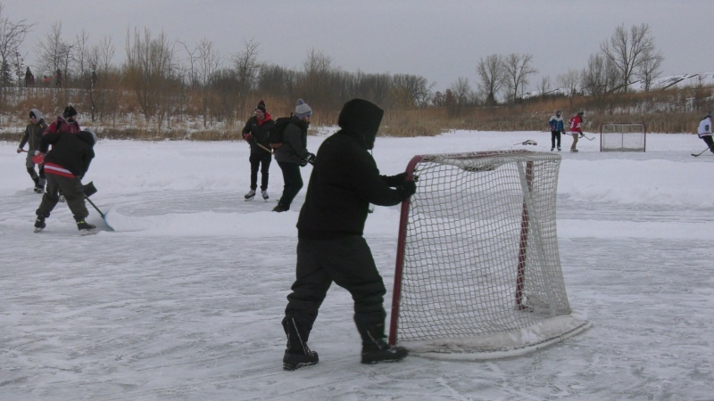 Group playing hockey and clearing snow from the ice for outdoor fun in Windsor, Ont. on Monday, Feb. 15, 2021. (Chris Campbell/CTV Windsor)