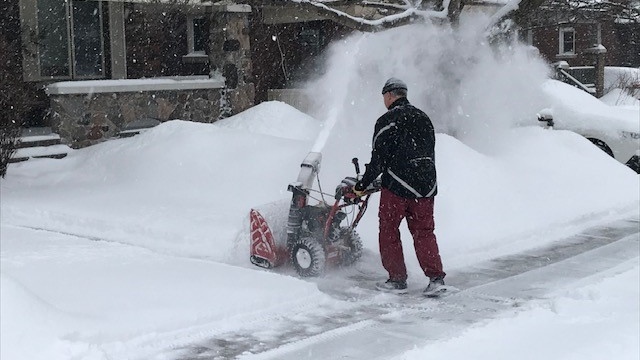 A resident clears snow from his driveway in Wellington Village on Tuesday, Feb. 16, 2021. (Jim O’Grady/CTV News Ottawa)