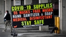 A man walks past a COVID-19 retail supplies sign during the COVID-19 pandemic in Toronto on Friday, February 5, 2021. THE CANADIAN PRESS/Nathan Denette