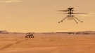 This illustration made available by NASA depicts the Ingenuity helicopter on Mars after launching from the Perseverance rover, background left. (NASA/JPL-Caltech via AP)