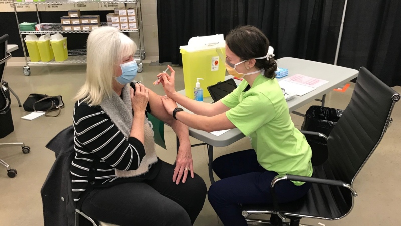Anne Doherty gets her first dose of the COVID-19 vaccine from nurse Hannah Currie in Mount Brydges, Ont. on Thursday, Feb. 18. 2021. (Sean Irvine / CTV News)