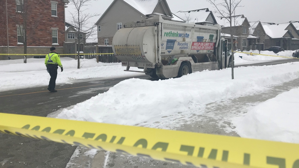 Waste collection truck with police tape in winter
