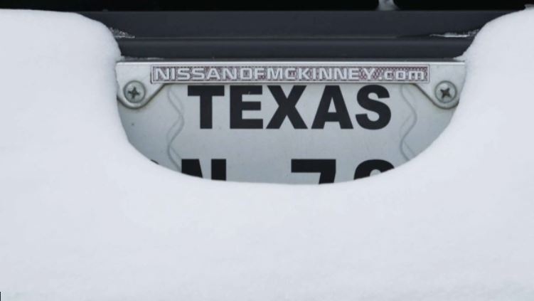 A snow-covered Texas license plate in February 2021.