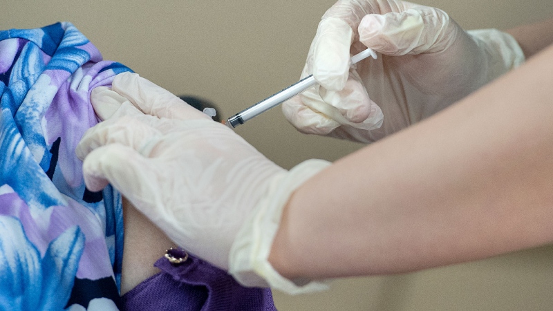 Amanda Parsons, a registered nurse on staff at the Northwood Care facility, administers a dose of the Moderna vaccine to Audrey Wiseman in Halifax on Monday, Jan. 11, 2021. THE CANADIAN PRESS / Andrew Vaughan-Pool