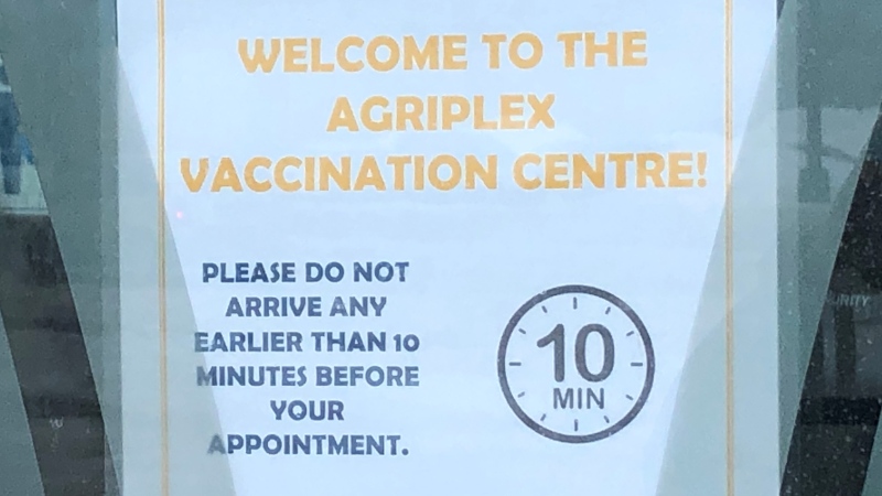 A sign in the door of the COVID-19 vaccination centre at the Western Fair District Agriplex in London, Ont. is seen Monday, Feb. 22, 2021. (Jim Knight / CTV News)