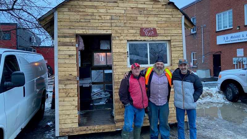 Guy Lamarche [middle] with two friends, visiting his new bunkie location in Arnprior. (Dylan Dyson / CTV News Ottawa)