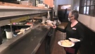 St. Thomas Roadhouse Restaurant server Tracy Tompkins delivers an order Feb 24, 2021. (Brent Lale/CTV London)