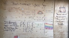 A group of volunteers gathered at the WE Trans office to transform a boarded-up wall after the organization was the target of vandalism in Windsor, Ont. on Wednesday, Feb. 24, 2021. (Alana Hadadean/CTV Windsor)