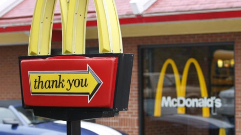 In this photo made on Wednesday, Oct. 14, 2009 a car moves the the drive through service behind the trademark golden arches of a McDonald's restaurant in Pittsburgh. (AP Photo/Keith Srakocic)
