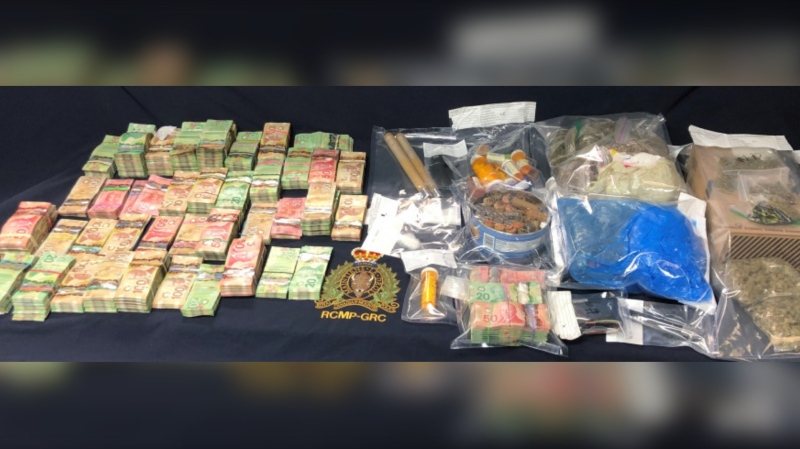 As a result, police say they seized various drugs including what is believed to be cocaine, prescription pills and cannabis. They also seized a substantial amount of money, prohibited weapons, and drug-trafficking paraphernalia. (Photo courtesy: RCMP)