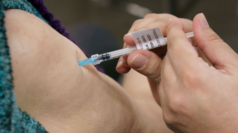 Seniors receive their COVID-19 vaccine at a clinic at Olympic Stadium marking the beginning of mass vaccination in the Province of Quebec based on age in Montreal, on Monday, March 1, 2021. THE CANADIAN PRESS/Paul Chiasson