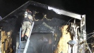 A firefighter battles hot spots in a house fire in Essex on Tuesday, March. 3, 2021. (Essex Fire and Rescue)