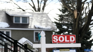 A for sale sign outside a home indicates that it has been sold, in Ottawa, on Monday, March 1, 2021. (Justin Tang/THE CANADIAN PRESS)