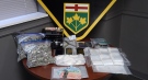 Drugs and cash seized from a residence in Plympton-Wyoming, Ont. on March 3, 2021 are seen in this image from OPP.