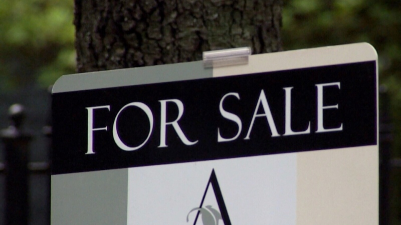 A for sale sign on a house. 
