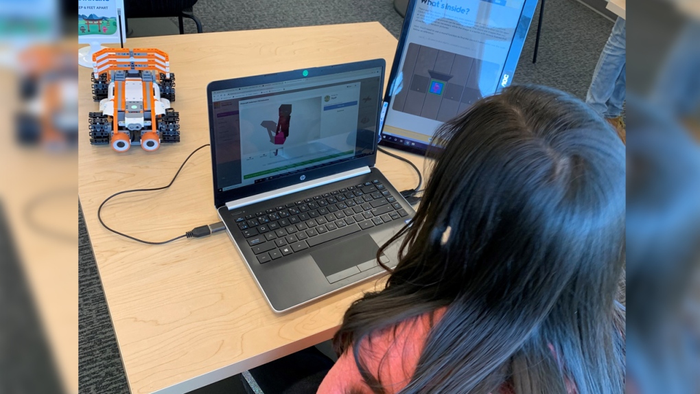 A child uses a computer to program