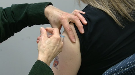 A woman gets the H1N1 flu vaccine at a Canadian clinic on Tuesday, Nov. 2, 2009.