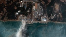 This satellite image provided by Maxar Technologies shows Fukushima Daiichi nuclear power plant and burning reactor in Okuma, Fukushima prefecture, Japan on March 14, 2011. Japan will mark the 10th anniversary of the 2011 earthquake, tsunami and nuclear disaster, on Thursday, March 11, 2021. (Satellite image ©2021 Maxar Technologies via AP)