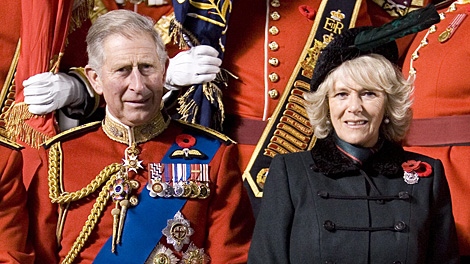 Prince Charles and Camilla, Duchess of Cornwall, pose for an official photo with soldiers from the Royal Canadian Regiment following a Colour Ceremony in Toronto on Thursday, Nov. 5, 2009. (THE CANADIAN PRESS/Chris Young)