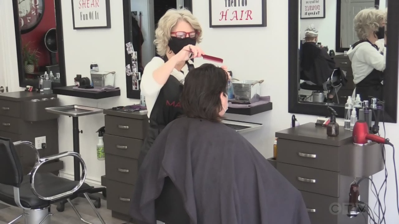 A client gets a haircut at Total Hair and Body Care in Petrolia, Ont. on March 13, 2021. (Brent Lale/CTV London)