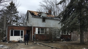 Investigators return to the scene of a fatal fire at a triplex in Barrie, Ont. on Tues. March 16, 2021 (KC Colby/CTV News)