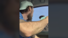 Hunter Johnson takes a ticket from a Sarnia Police Service officer in a video posted to Facebook. (Source: Hunter Johnson/Facebook) 