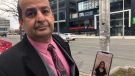 Nasser Hashemi poses with a photo of Kiana Ghasemi, a George Brown College student who died after Ukraine International Airlines Flight 752 was shot down by the Iranian military. (CTV News Toronto/Beth Macdonell)