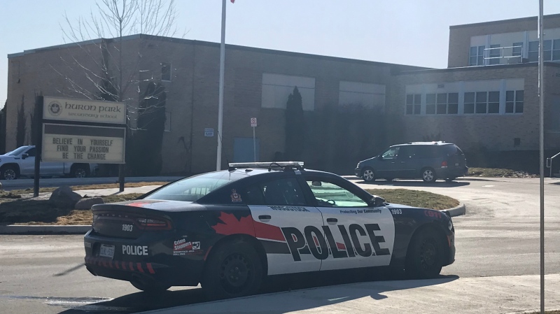 A police cruiser is parked outside Huron Park Secondary School in Woodstock, Ont. on Friday, March 19, 2021. (Tyler Calver / CTV Kitchener)