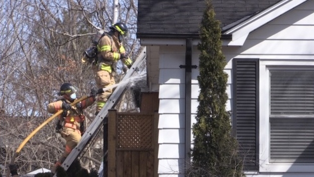 Crews work at the scene of a house fire on Balderstone Avenue in London, Ont. on Friday, March 19, 2021. (Daryl Newcombe / CTV News)