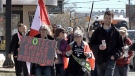 A crowd of up to 300 people march in Victoria Park, continuing down Richmond Street - Saturday, March 20, 2021 (Jim Knight / CTV News)