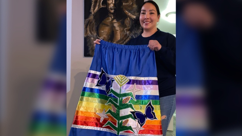 Agnes Woodward stands with the ribbon skirt she designed for new U.S. Secretary of the Interior Deb Haaland to wear at her swearing-in. (Courtesy: Agnes Woodward)