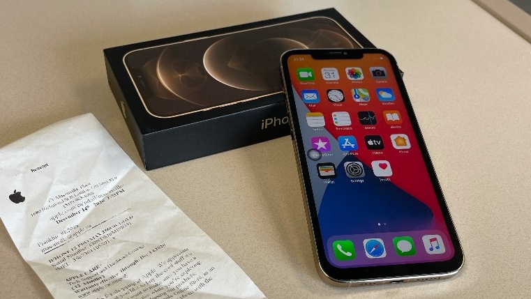 The fake Apple iPhone 12 Pro Max can be seen in this photo, along with a fake Apple box and receipt used by scammers. (Supplied)