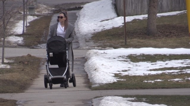 A mother pushes a stroller down a London, Ont. sidewalk. (Daryl Newcombe / CTV London)