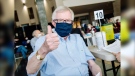Former Prime Minister Joe Clark, 81, gives the thumbs up after receiving his first dose of the COVID-19 vaccine at Ottawa City Hall, March 23, 2021. (Photo by Chris Bricker, City of Ottawa)