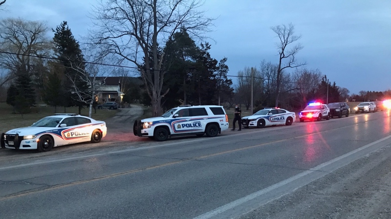 Police vehicles line Longwoods Road in London, Ont. on Thursday, March 25, 2021. (Sean Irvine / CTV News)