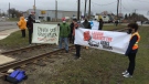 Activists protesting the sale of arms to Saudi Arabia block a railway line near General Dynamics Land Systems in London, Ont. on Friday, March 26, 2021. (Bryan Bicknell / CTV News)