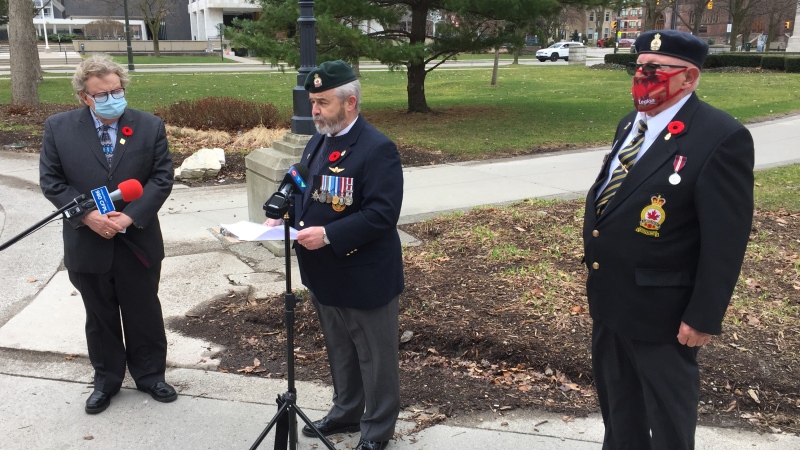 From left, London Mayor Ed Holder, Royal Canadian Legion Zone Commander Randy Warden and Donnybrook branch 1st Vice President Ross Seip speak at Victoria Park in London, Ont. on Friday, March 26, 2021. (Bryan Bicknell / CTV News)