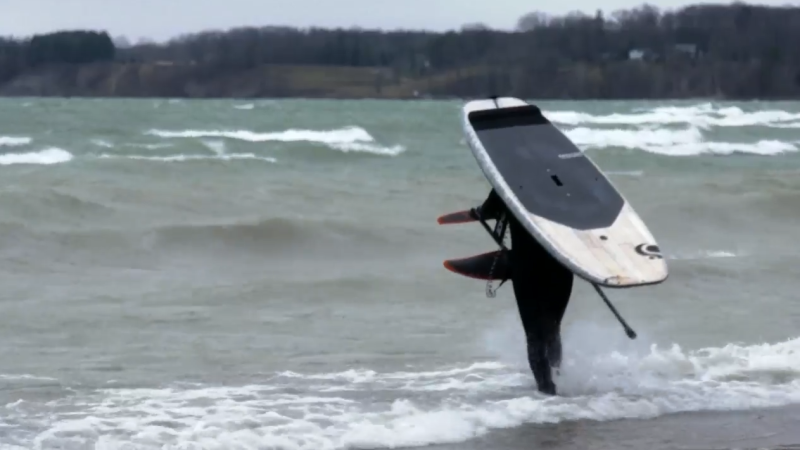 A foil surfer takes advantage of the high winds and waves of Lake Erie in Port Dover, Ont. on Friday, March 26, 2021. (Marek Sutherland / CTV News)