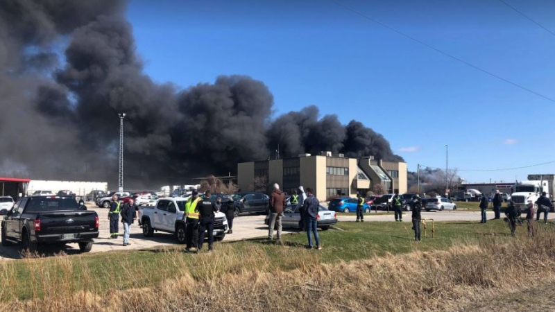 Smoke can be seen billowing from Flying M Truck Service on Colonel Talbot Road in London, Ont. on March 29, 2021. (Justin Zadorsky/CTV London)