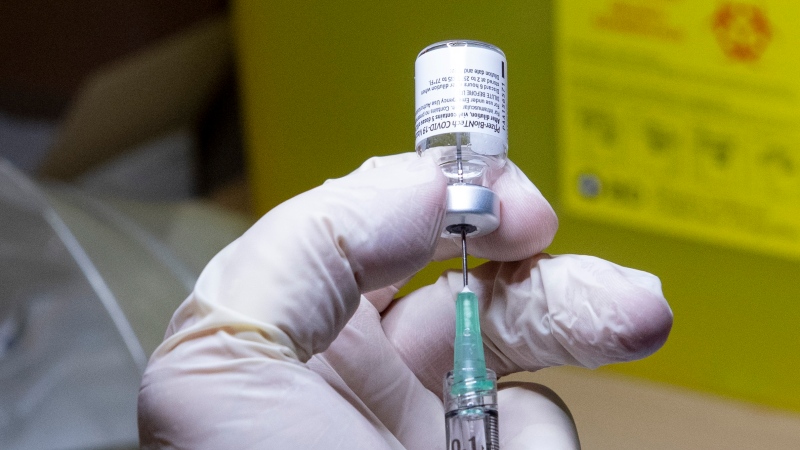 A Pfizer-BioNTech COVID-19 vaccine dose is prepared in Toronto on Monday, Dec. 14, 2020. THE CANADIAN PRESS/Frank Gunn